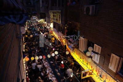Top view of people in Matareya sharing their iftar together in the street, Ramadan Kareem, preparing their iftar