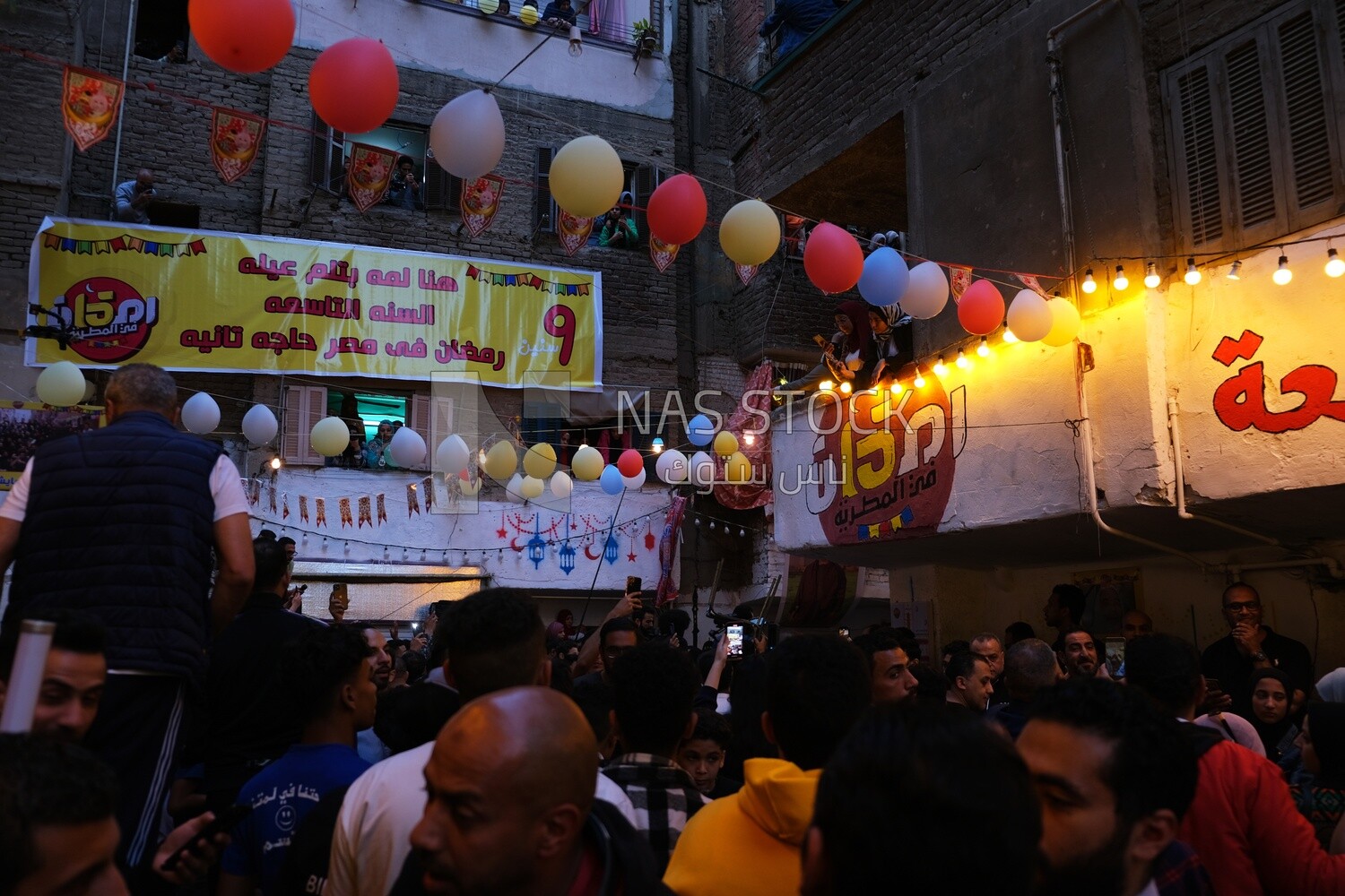 View of people in Matareya sharing their iftar together in the street, Ramadan Kareem, preparing their iftar