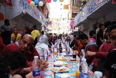 View of people in Matareya sharing their iftar together in the street, Ramadan Kareem, preparing their iftar