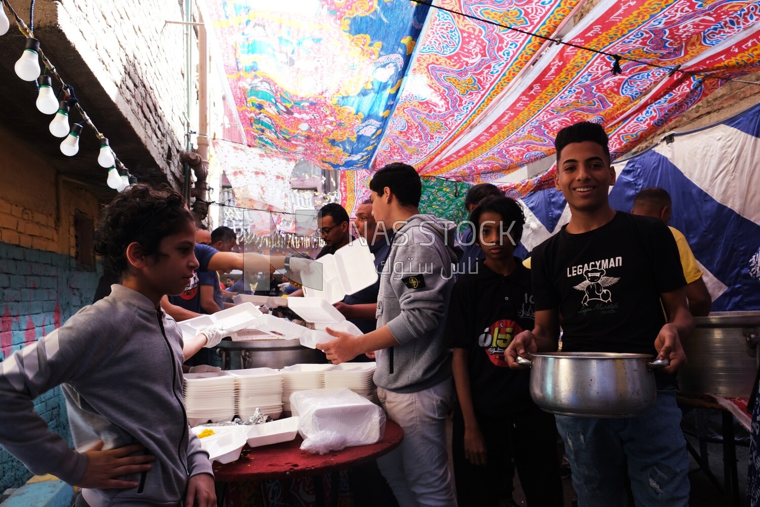 Photo of men organizing the event of iftar Matareya, Ramadan Kareem, preparing their iftar