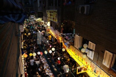 Top view of people in Matareya sharing their iftar together in the street, Ramadan Kareem, preparing their iftar