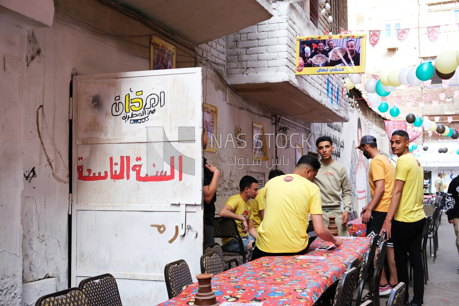View of people in Matareya sharing their iftar together in the street, Ramadan Kareem, preparing their iftar