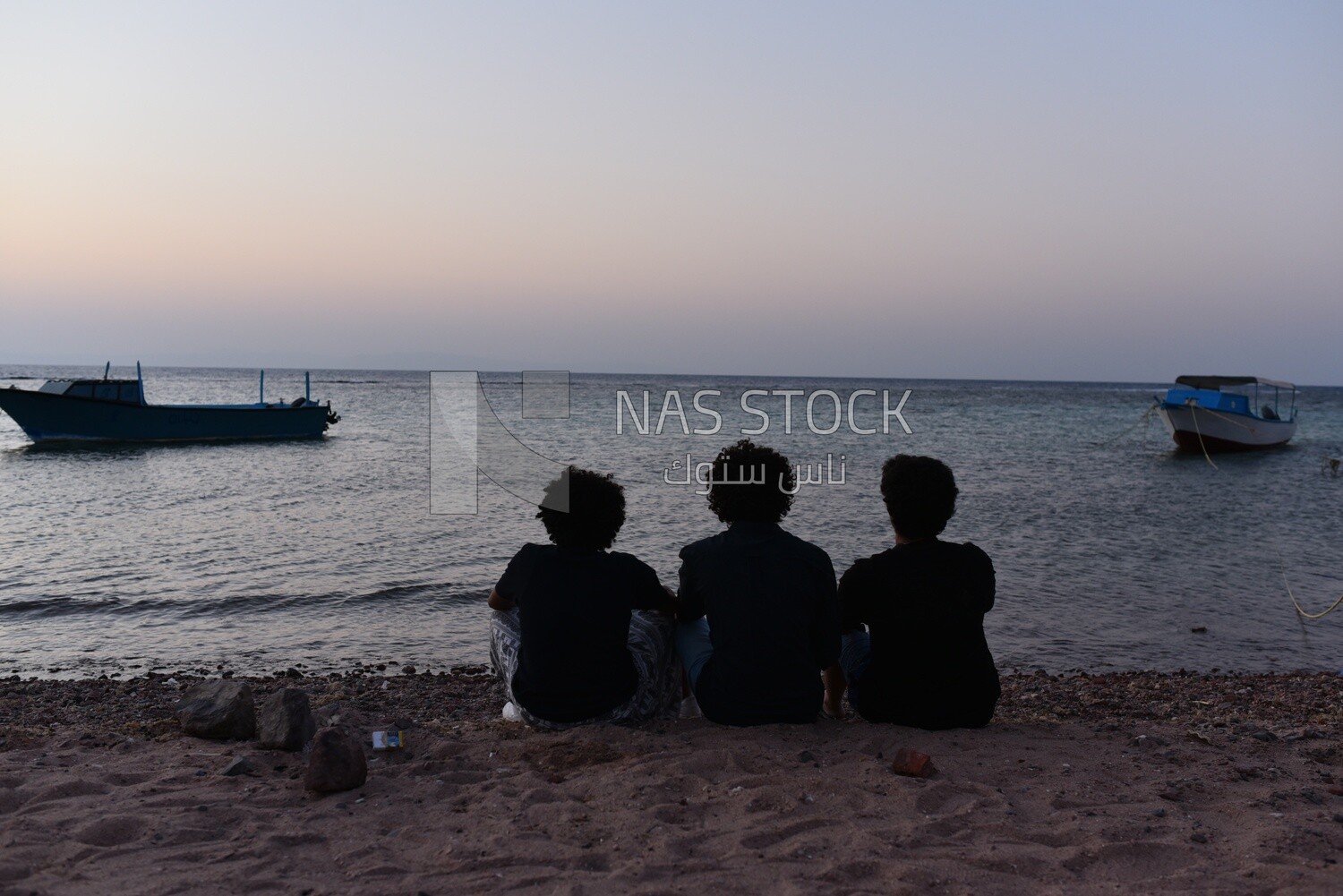 Group of friends sitting on the beach