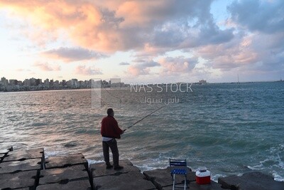 Man fishing with a rod in the sea of Alexandria