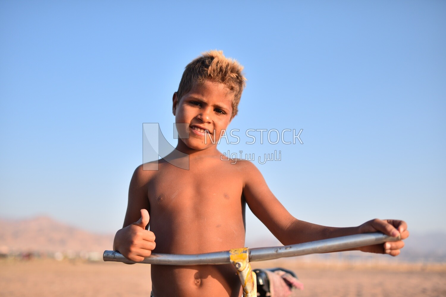 Child in a swimsuit takes a photo