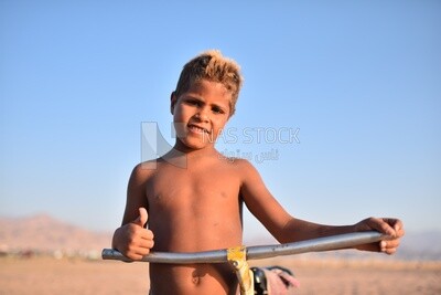 Child in a swimsuit takes a photo
