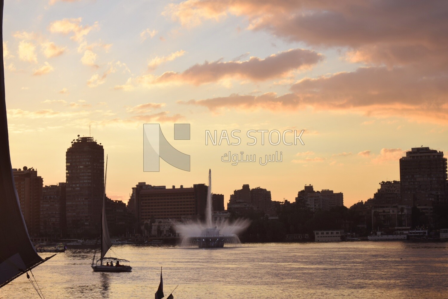 Picture showing the Nile River fountain pumping water at sunrise with sailboats around it