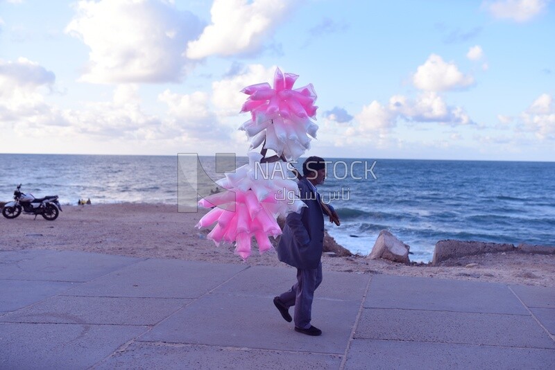 Man sells cotton candy on the beach