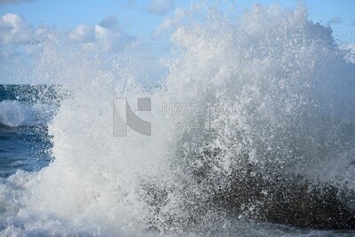 Big waves crash onto the shore