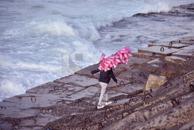 Man sells cotton candy on the beach