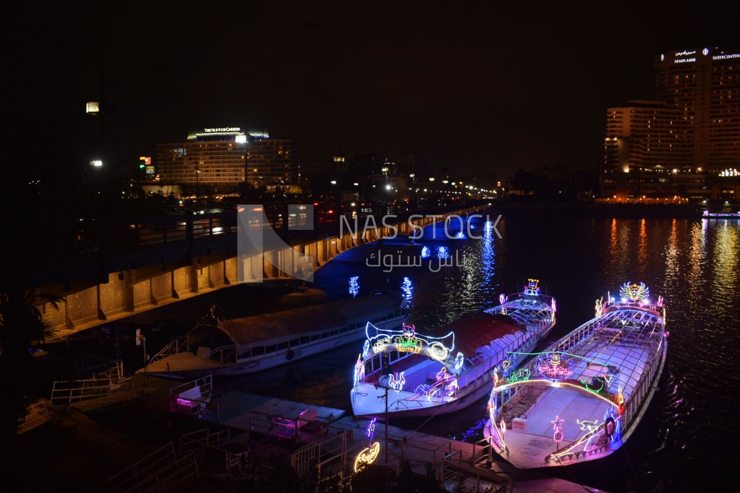 Pictures showing the Qasr El Nil Bridge passing between the Semiramis Hotel and the Nile Ritz-Carlton Hotel