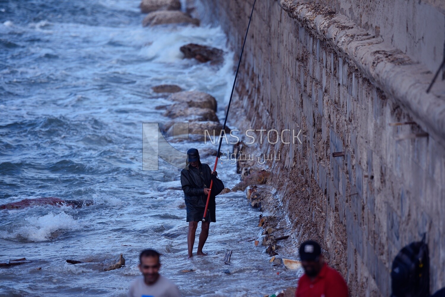 Man fishing with a rod in the sea of Alexandria, Egypt