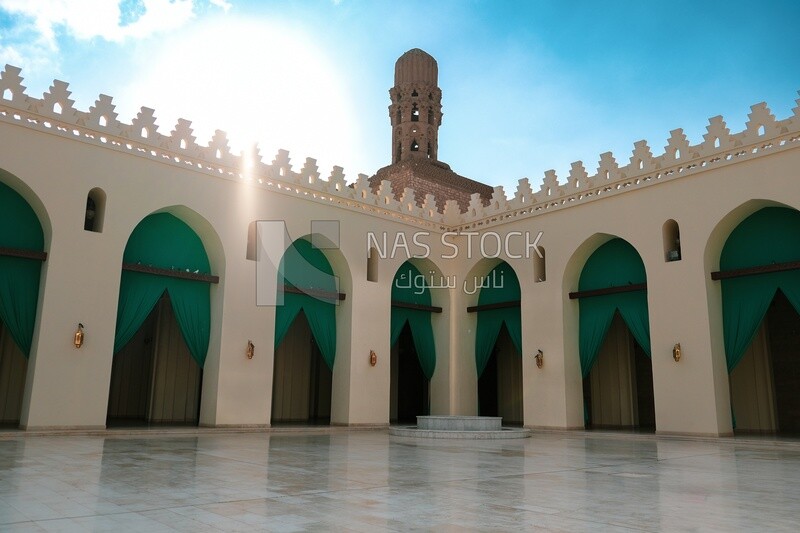 Minaret of Al-Hakim Mosque with the courtyard and the mosque&#39;s arches in cairo egypt