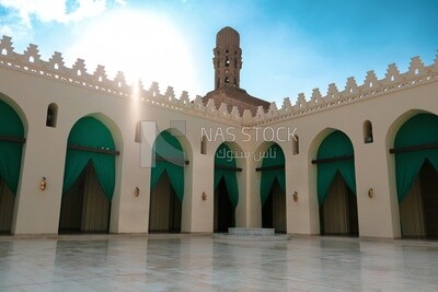 Minaret of Al-Hakim Mosque with the courtyard and the mosque&#39;s arches in cairo egypt