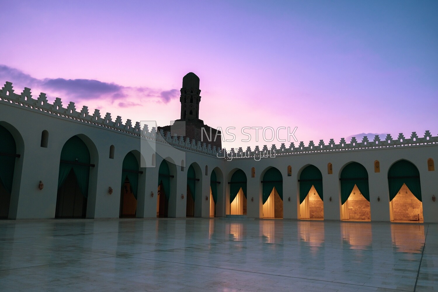 Minaret of Al-Hakim Mosque with the courtyard and the mosque&#39;s arches in cairo egypt