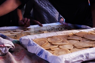Man selling in a bakery, street, decoration lights