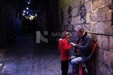 Man sitting with her daughter in the street, street,  decorations, Ramadan Kareem