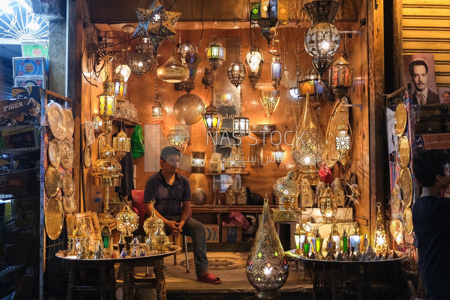 Man sitting in a lights shop in Al Moez street, street,  decorations, Ramadan Kareem