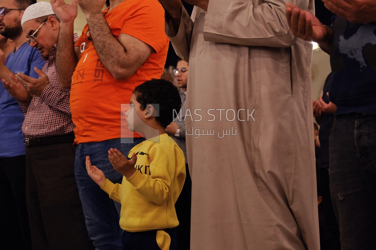 Boy in the mosque, praying on the prayer rug, performing the obligatory prayer in the mosque, worship and draw close to God