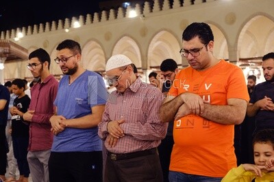 Worshipers praying in a mosque, performing the obligatory prayer in the mosque, worship and draw close to God