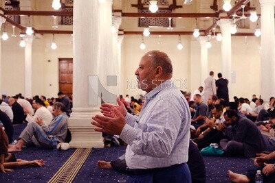 Man in the mosque, praying to God, praying on the prayer rug, performing the obligatory prayer in the mosque, worship and draw close to God