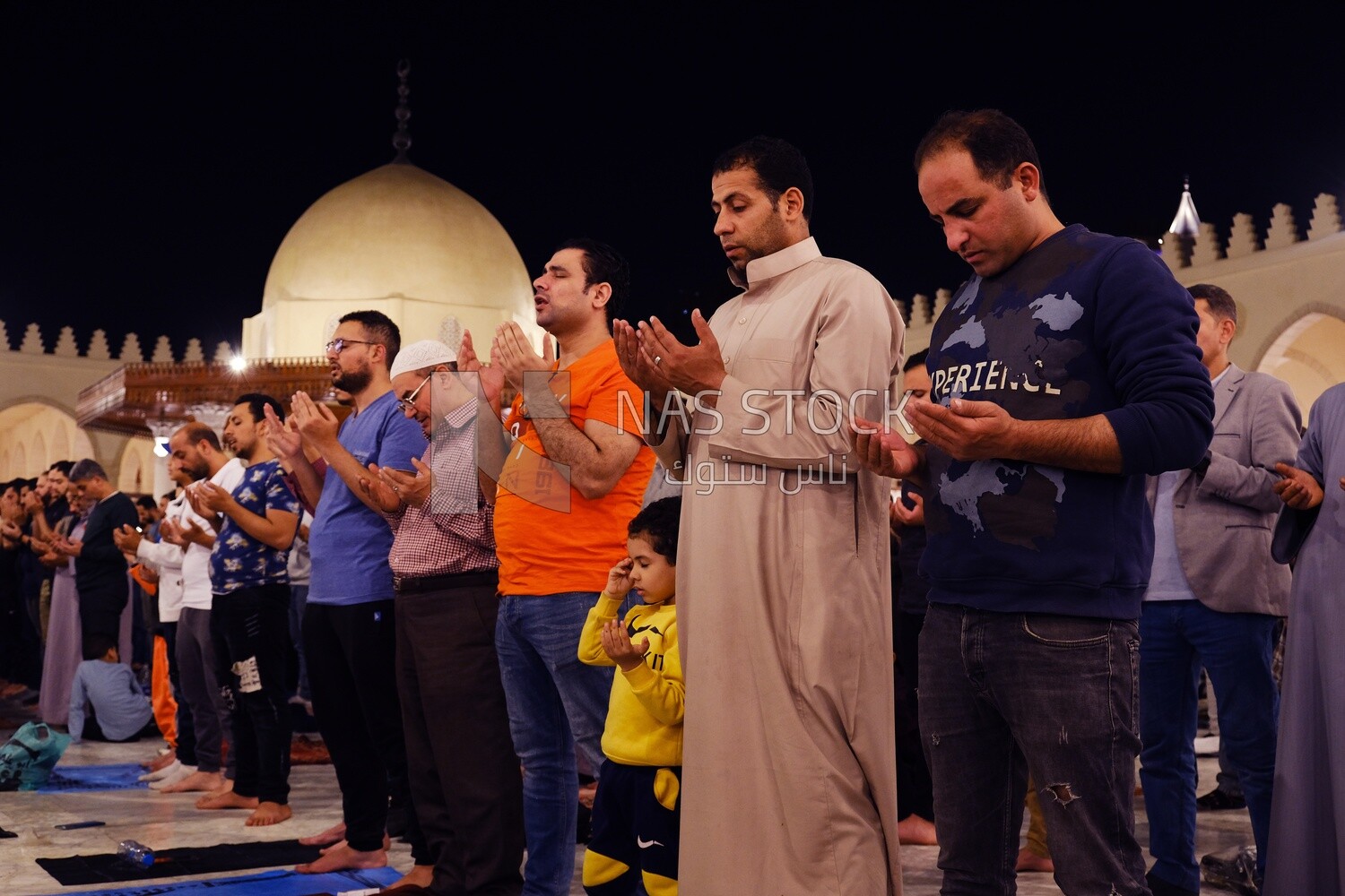 Worshipers praying in a mosque, performing the obligatory prayer in the mosque, worship and draw close to God