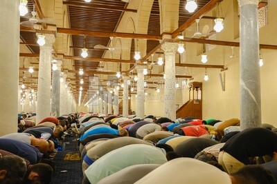 Worshipers praying in a mosque, performing the obligatory prayer in the mosque, worship and draw close to God