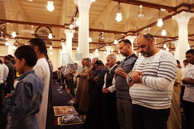 Worshipers praying in a mosque, performing the obligatory prayer in the mosque, worship and draw close to God