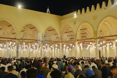 Worshipers praying in a mosque, performing the obligatory prayer in the mosque, worship and draw close to God