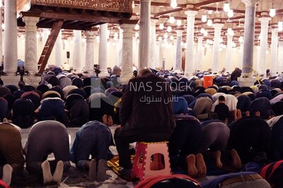 View from the back of the worshipers in the mosque, performing the obligatory prayer inside the mosque, reverence in prayer, performing the obligatory prayer in the mosque, worship and getting closer