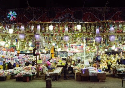 People in a street shop selling lanterns, Hanging lanterns, Sayeda Zainab and Ramadan Kareem.