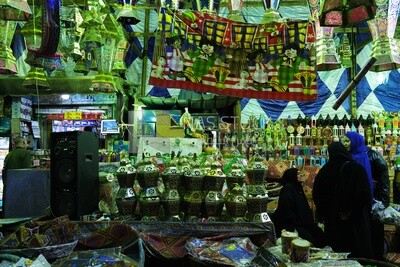 People in a street shop selling lanterns, Hanging lanterns, Sayeda Zainab and Ramadan Kareem.