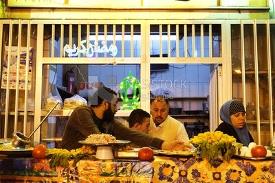 People standing in a street restaurant, traditional breakfast, street food