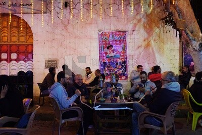 People sitting in a street coffee shop, Ramadan