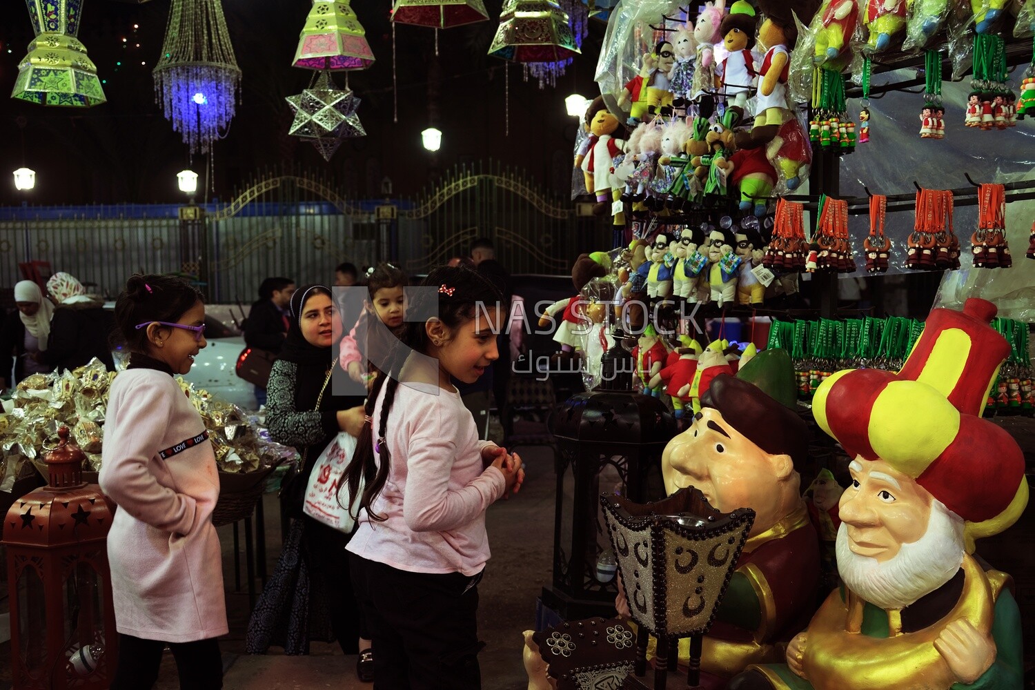 People in a street shop selling lanterns, Hanging lanterns, Sayeda Zainab and Ramadan Kareem.