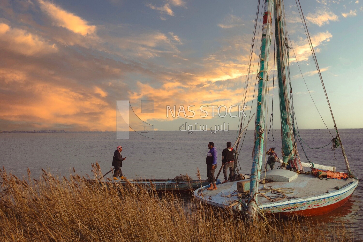 Fishermen on top of a boat in the middle of the sea