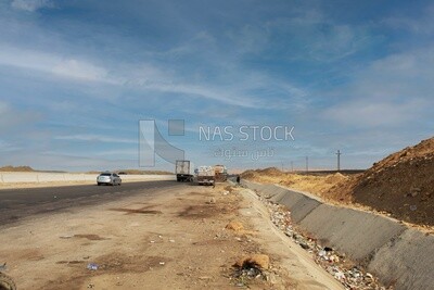 Desert road and some transport trucks parked on the road
