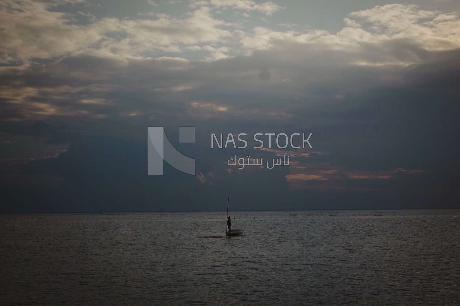 Burullus lakes during sunset, a fishing boat is in the middle of its waters
