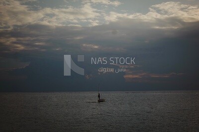 Burullus lakes during sunset, a fishing boat is in the middle of its waters