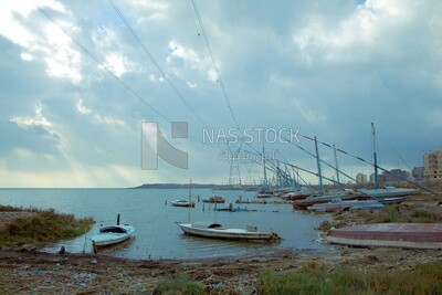 Group of good and dilapidated fishing boats in front of the beaches of the city of Burullus
