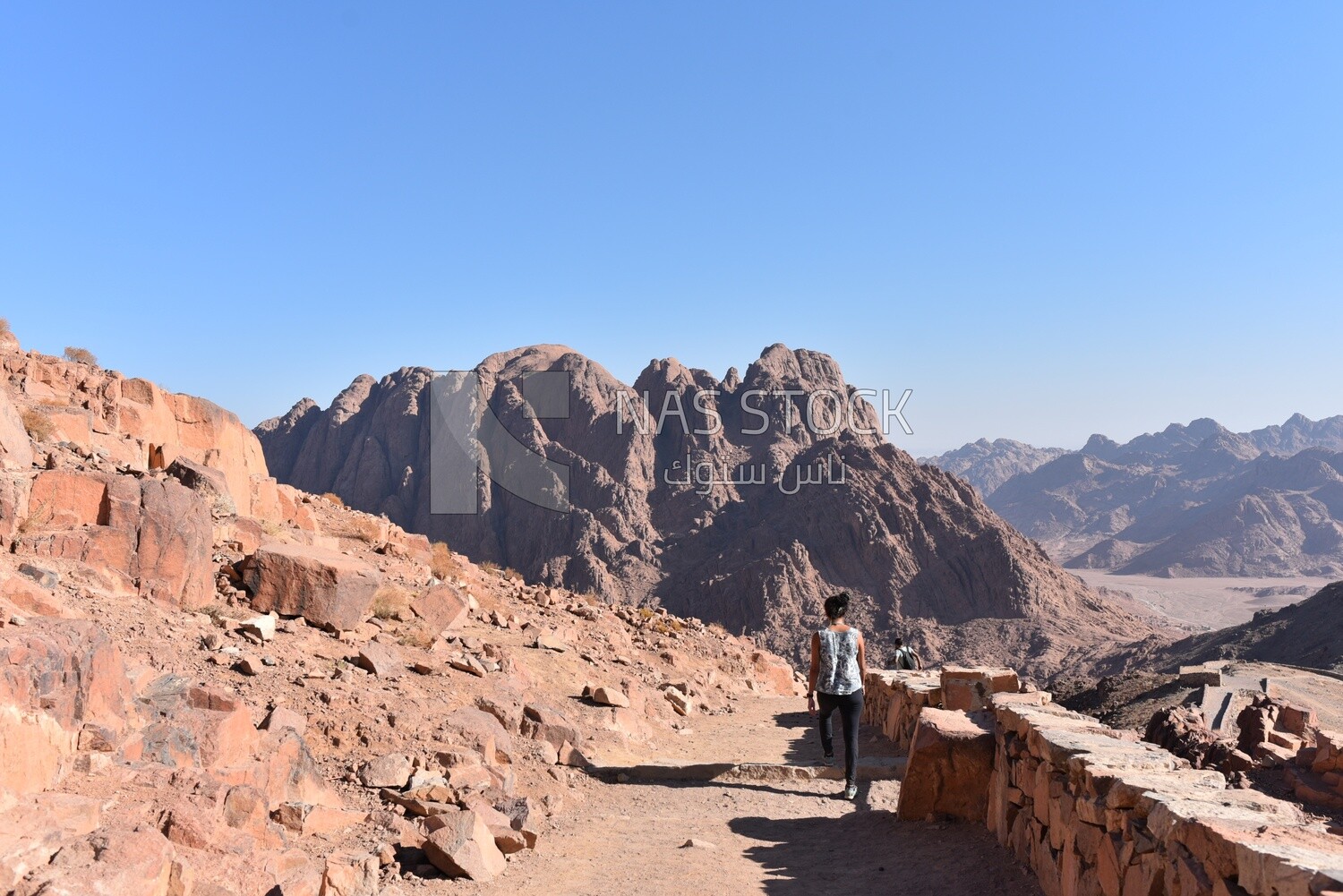 Girl enjoys walking among the mountains and rocky landscapes