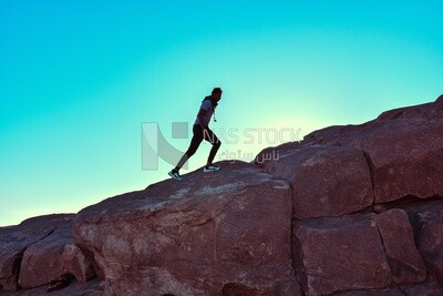 Young man goes up to the mountain at sunrise