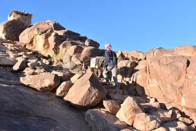 Bedouin man climbing a mountain