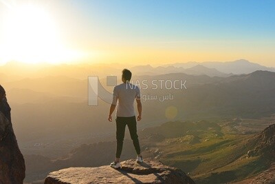 Traveler stands on the edge of the abyss on the top of the mountain