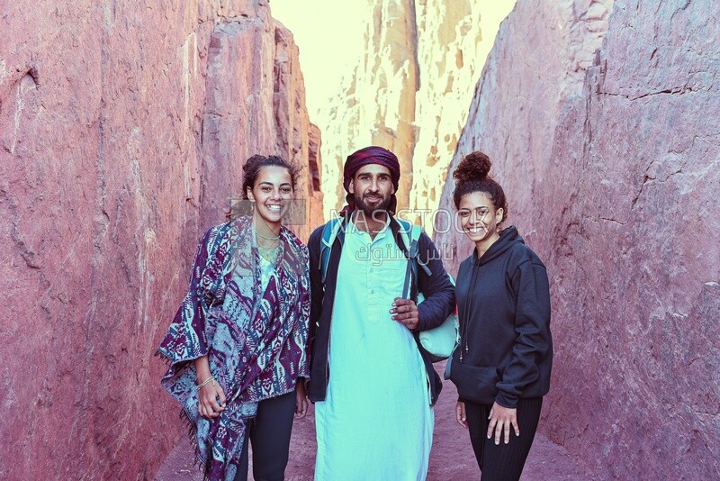 Tourists take a photo with a Bedouin man, Egypt