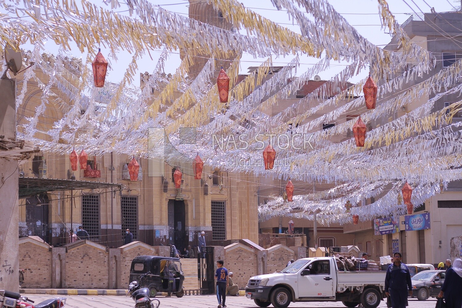 View of a street full of decorations and hanging lanterns in the middle, Ramadan vibes