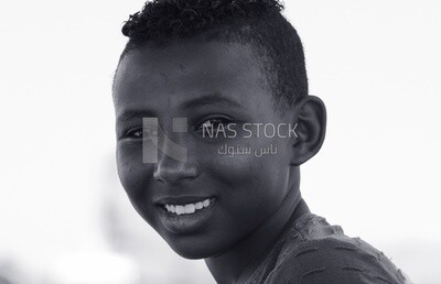 Child with brown skin and a gentle smile from Aswan, Egypt