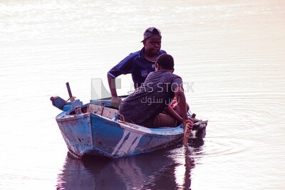 Two children riding a wooden boat ,Aswan, Egypt