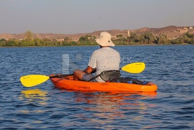 Man enjoys the outdoors and paddling on the Nile River, Egypt