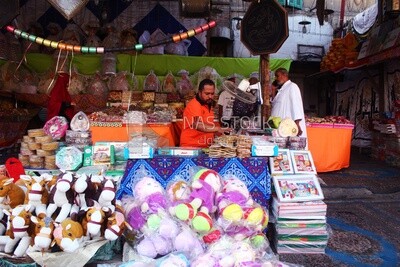 Man standing selling the candies of the prophet Muhammad&#39;s birth in the street